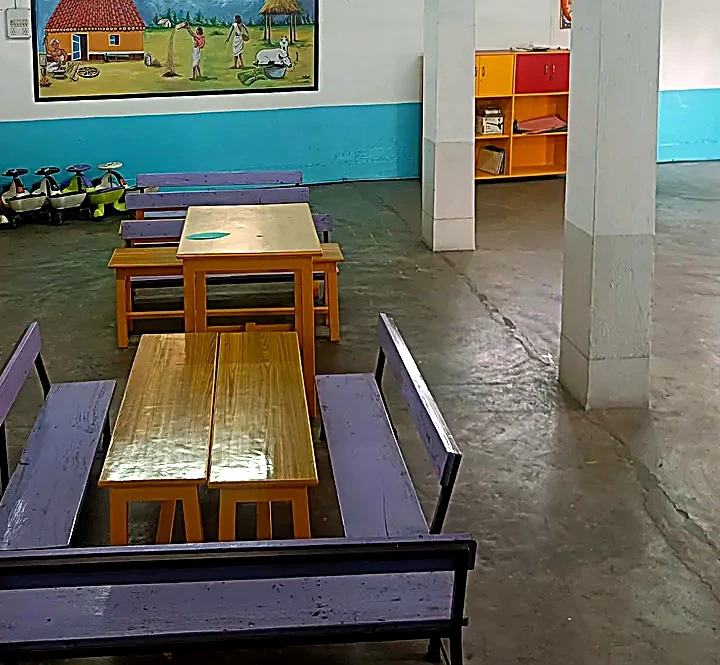 Samridhi Day Care Centre activity room with child-sized tables, learning displays, and play equipment in Mango Jamshedpur
